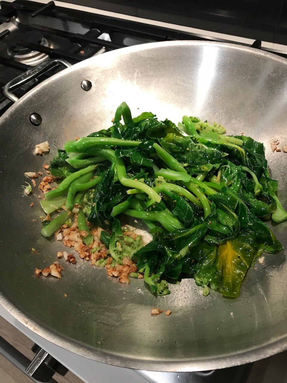 Wilted gailan in a frying pan