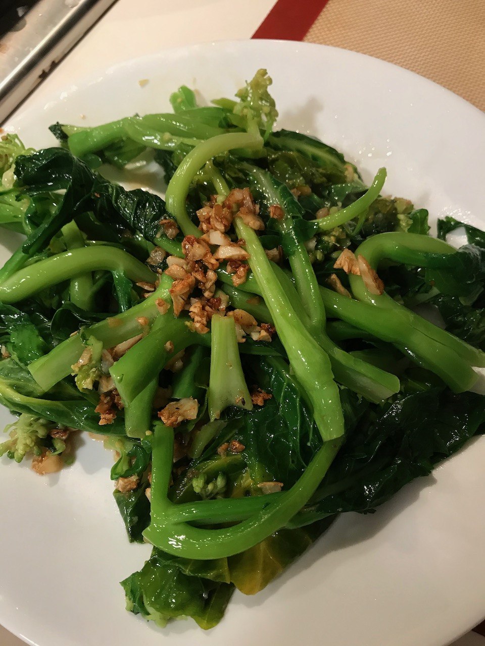 Sauteed gailan with garlic on a plate